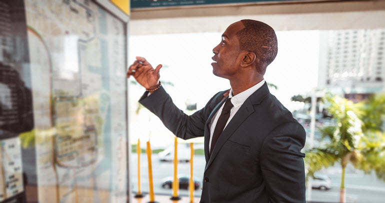 Man looks at a subway map to plan his route